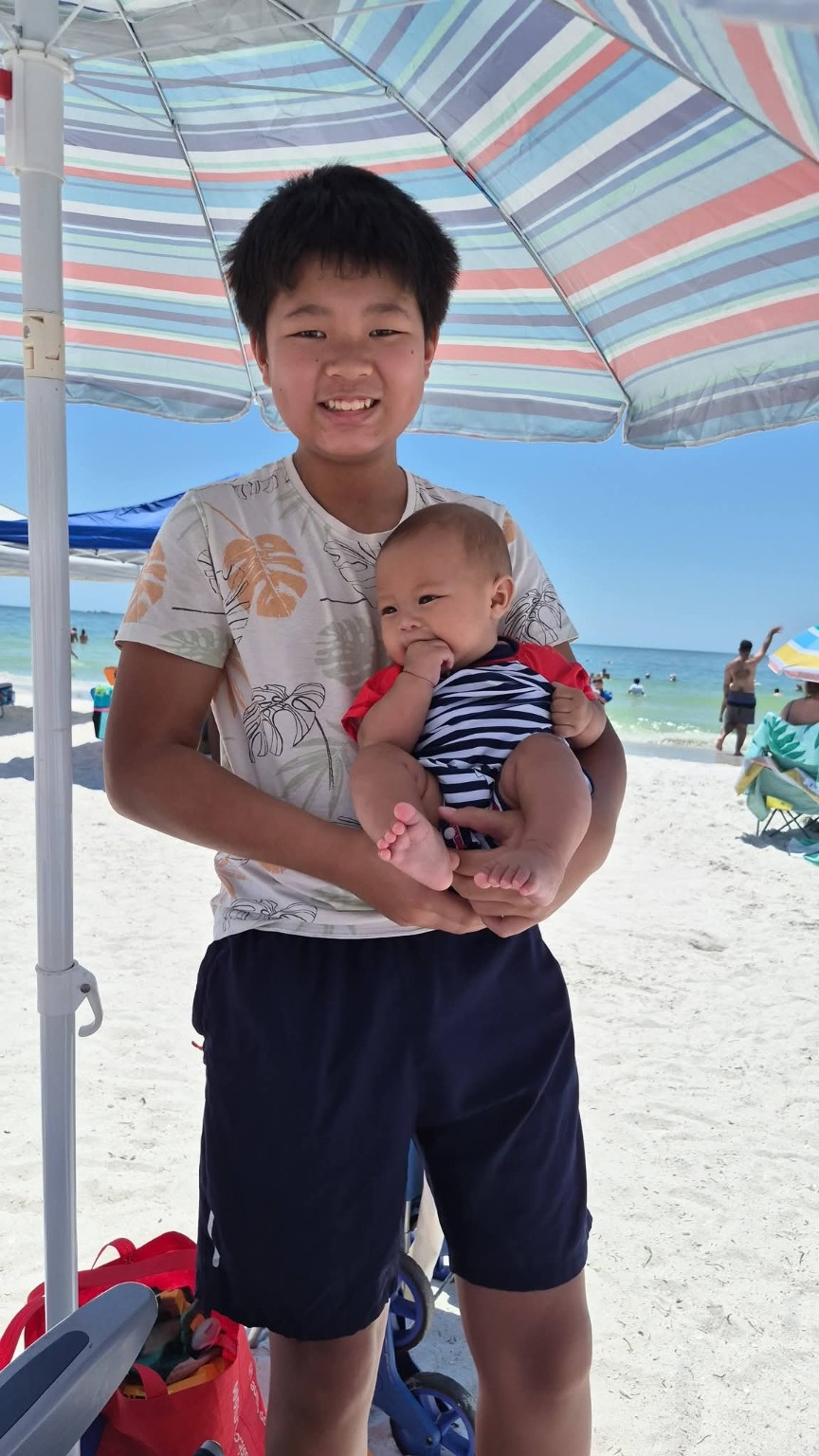 Atreo holding baby Koa at Clearwater Beach