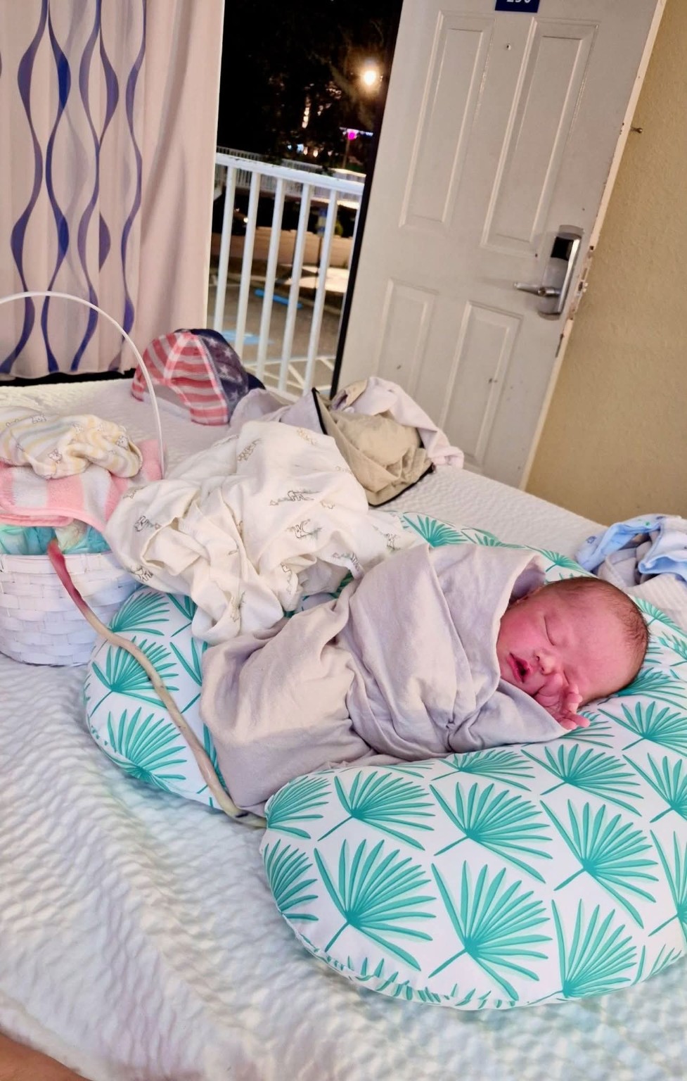 Newborn Koa resting in the Clearwater hotel room where he was born